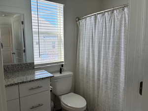 Full bathroom with a shower with curtain and vanity