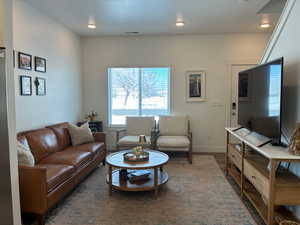 Living room featuring wood finished floors and recessed lighting