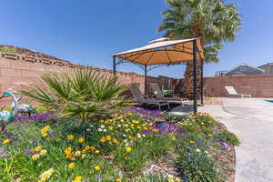 Fenced backyard with a patio and a gazebo
