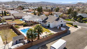 Aerial perspective of neighborhood featuring a mountainous background and a pool