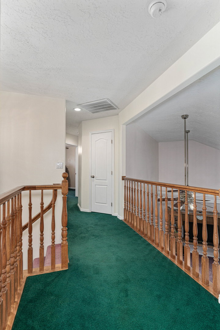 Upstairs landing looking toward primary bedroom. In the opposite direction there are an additional 3 bedrooms and full bathroom.