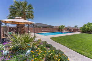 View of swimming pool with patio surround, a fenced backyard, and a gazebo