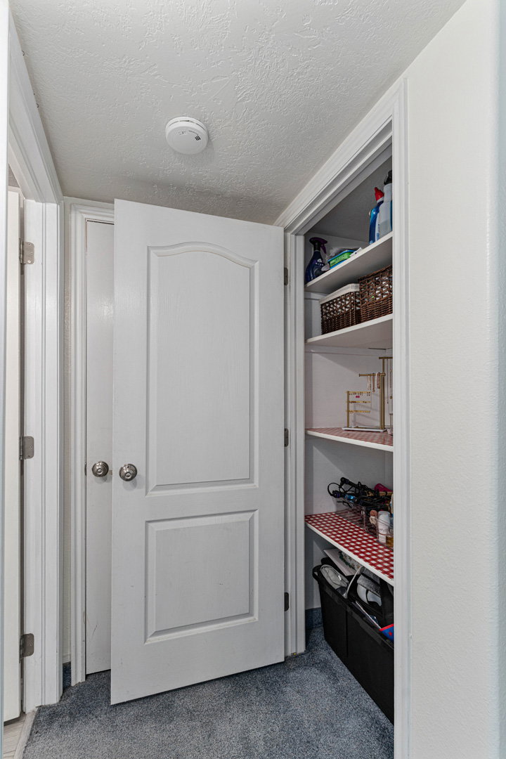 Additional storage closed across from the downstairs bathroom. The door in the back leads to the walk-storage room that will wrap around and come out in the downstairs living room.
