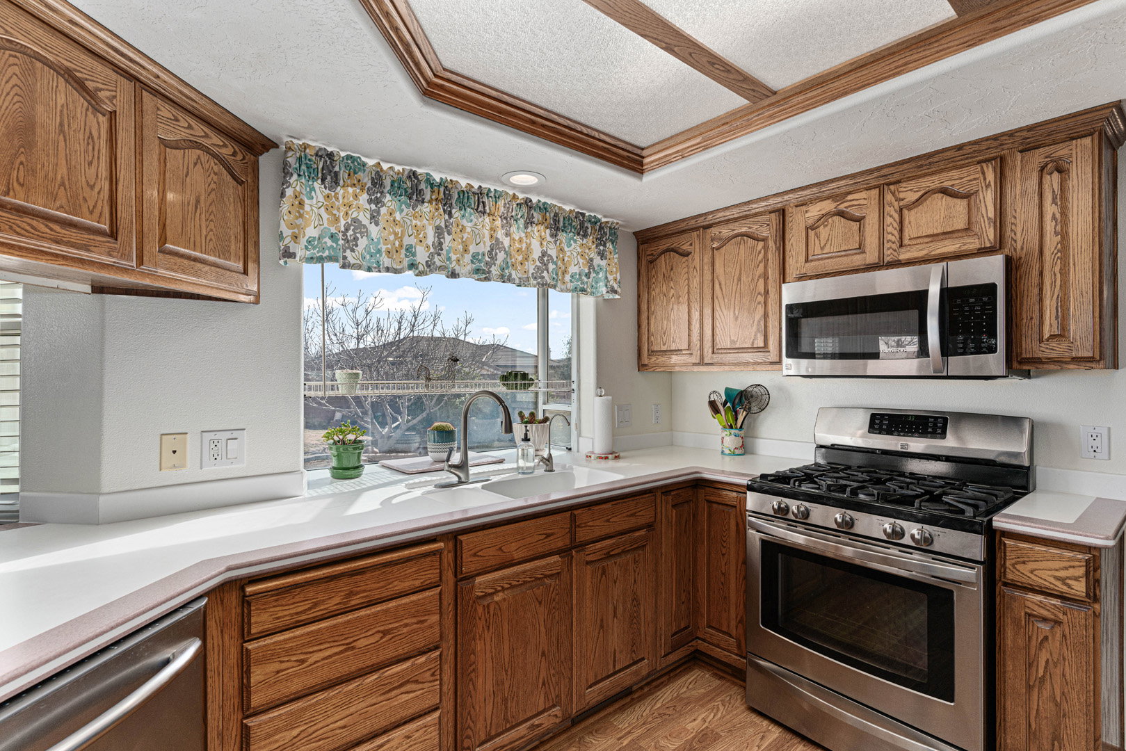 Kitchen with views into the backyard/pool area from the bay window.