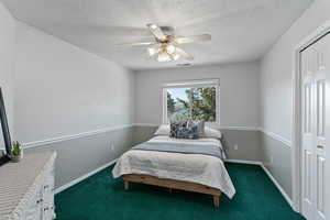 Primary bedroom looking from the bathroom towards the entrance. There is a built-in tv/entertainment area to the right of the door leading out.