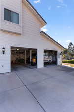 View of side of home featuring a garage and driveway