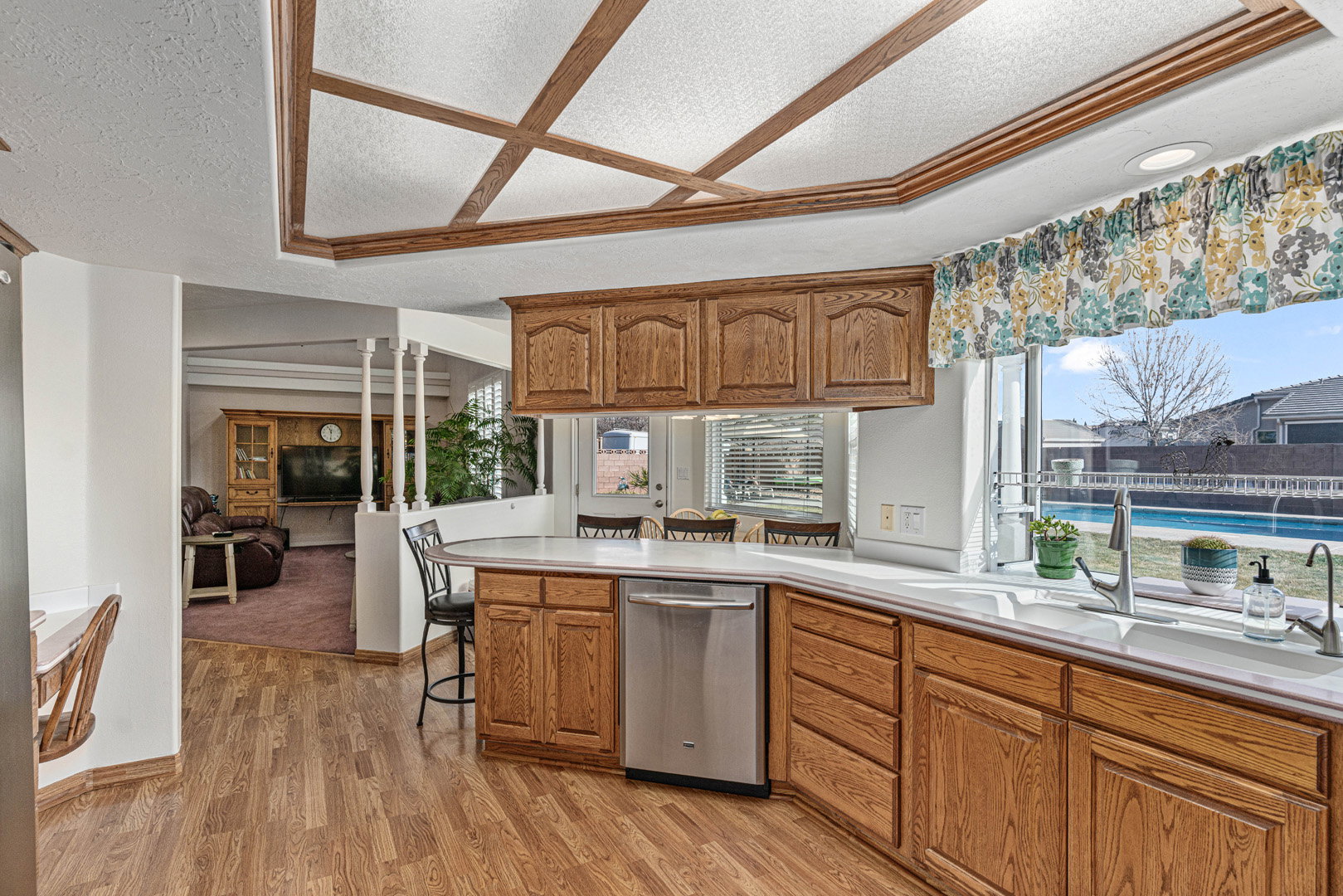 Kitchen and dining nook area that also connects to a large family/tv room with vaulted ceilings.