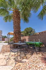 Fenced backyard with outdoor dining area and a patio