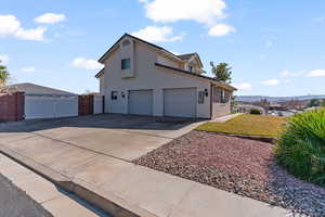 Two car garage and a large driveway and side area for additional RV/boat parking.
