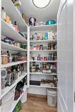 Large kitchen pantry.just to the left of the refrigerator.
