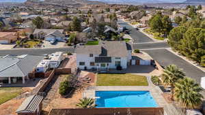 Aerial perspective of neighborhoo with a pool area and a mountain backdrop