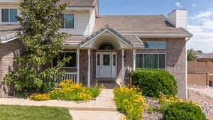 Welcoming, beautiful front entrance with a quant little porch with room for a bench to watch the sunset.