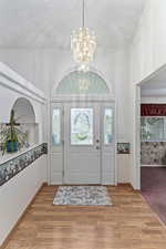 Open front entry with office to the right and formal living room to the left.