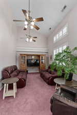 Large living/tv room with windows looking into backyard/pool area.