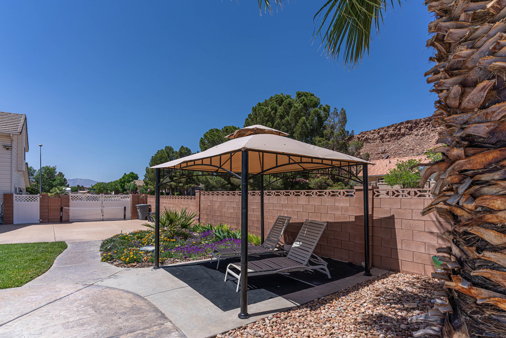 Fenced backyard with a gazebo, a patio area, and a mountain view