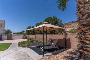 Fenced backyard with a gazebo, a patio area, and a mountain view