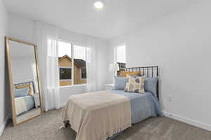 Bedroom featuring baseboards and carpet floors