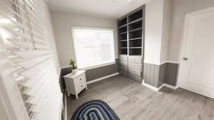 Walk in closet with light wood-style flooring