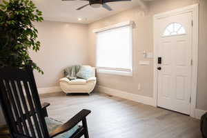 Entrance foyer featuring wood finished floors and ceiling fan