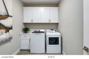 Laundry area with cabinet space and separate washer and dryer
