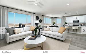 Living area with ceiling fan, light wood finished floors, and recessed lighting