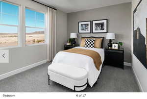 Bedroom with baseboards and carpet