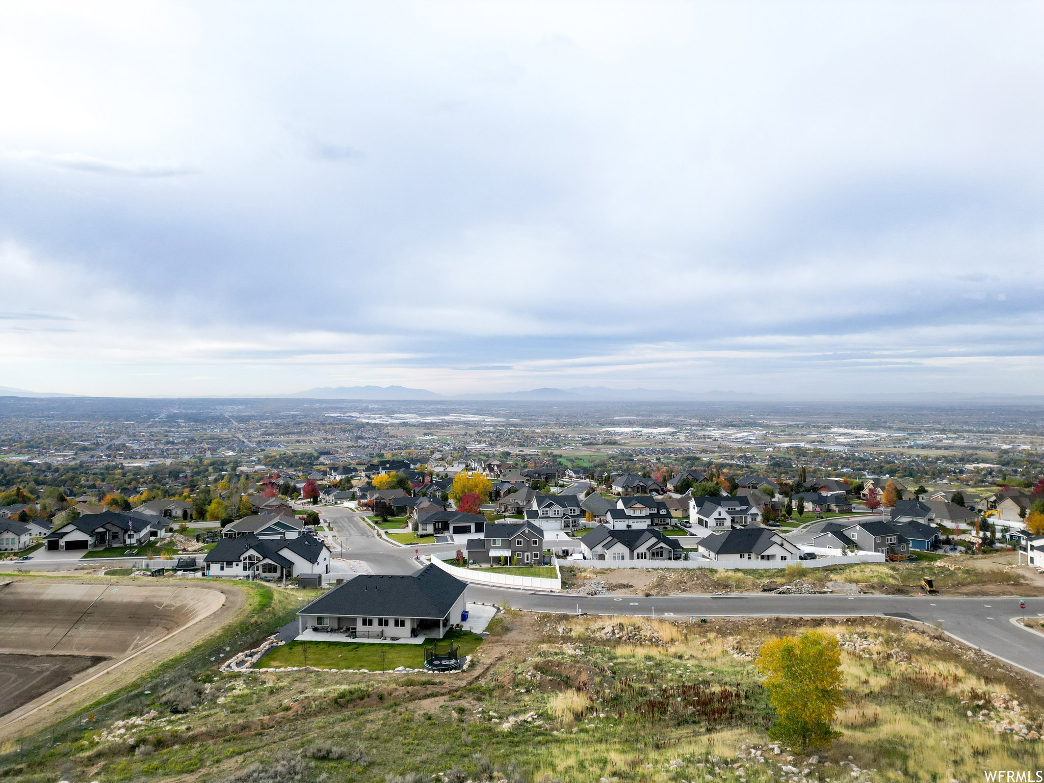 Aerial view of residential area featuring a mountainous background