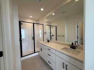 Primary ensuite bathroom with dual vanity, walk in shower, and separate toilet room.