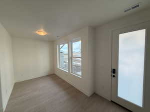 Front door enters into open flex space with large windows