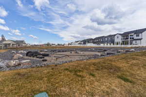 View of green lawn featuring a residential view
