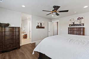 Primary bedroom with dark wood finished floors, ceiling fan, recessed lighting, and a textured ceiling