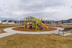 Community jungle gym featuring a residential view and a lawn