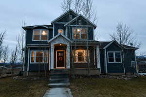 View of front of home with a front lawn and a porch