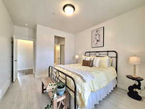 Bedroom featuring light wood-style flooring and baseboards