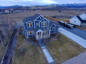View of front of house featuring a mountain view and a front lawn