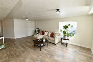 Living room featuring a textured ceiling and light wood finished floors