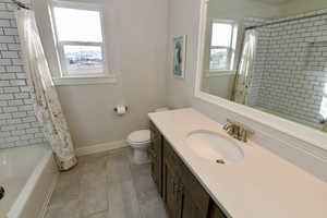 Bathroom with vanity and shower / tub combo with curtain