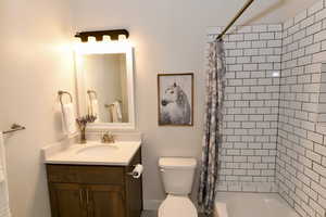Bathroom with vanity and shower / bath combo with shower curtain