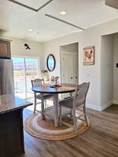 Dining room featuring dark wood-type flooring and recessed lighting