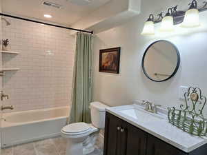 Bathroom with vanity, shower / bathtub combination with curtain, light tile patterned floors, and recessed lighting