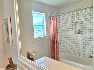 Bathroom with shower / tub combo and vanity