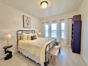 Bedroom featuring light wood finished floors and baseboards