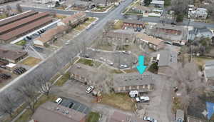 Aerial view of property and surrounding area featuring nearby suburban area