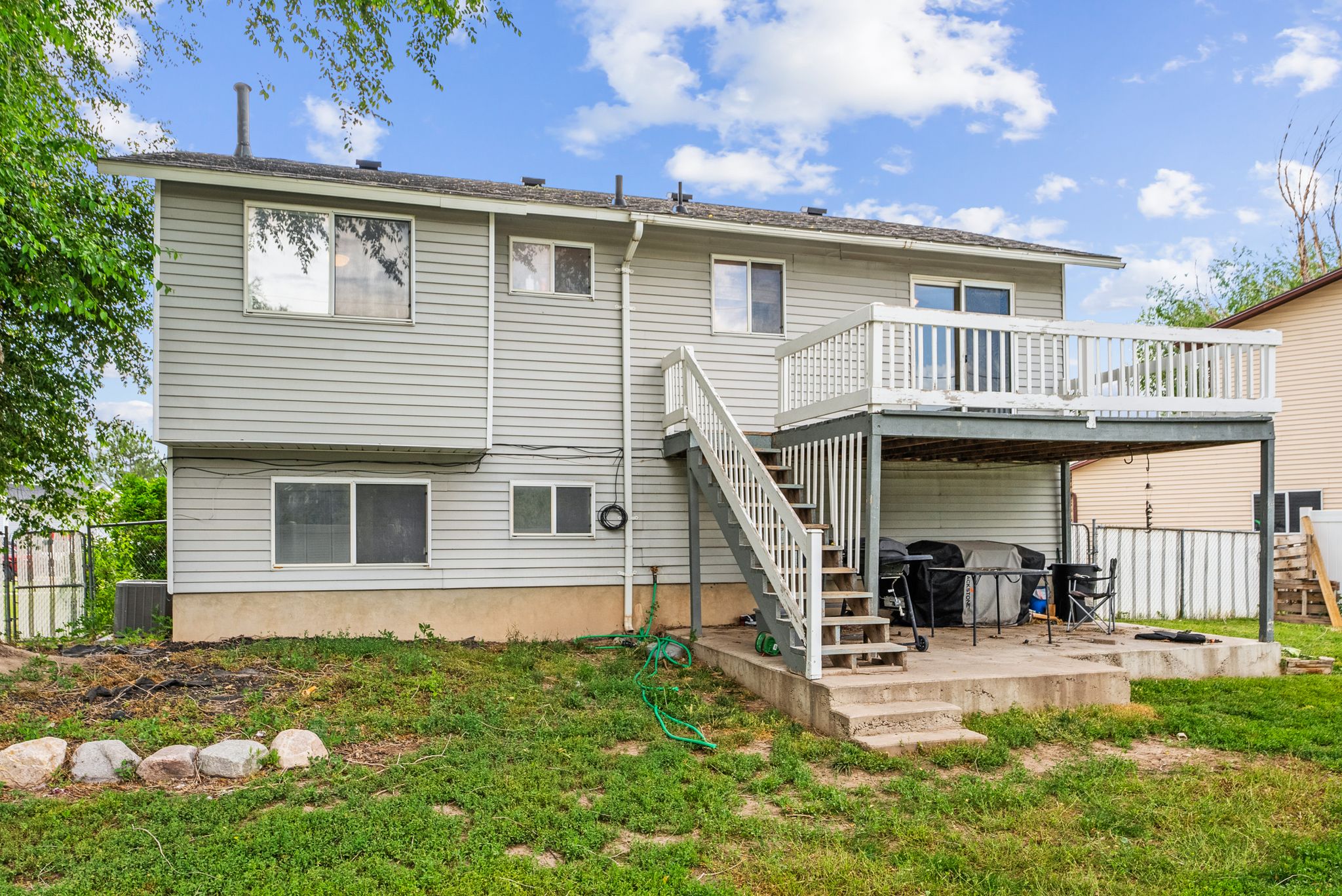 Rear view of house with a deck and a patio area