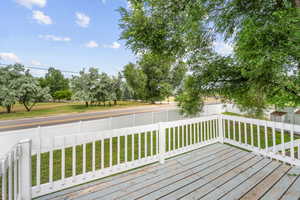 Wooden deck with a fenced backyard