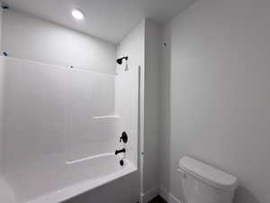 Full bath with toilet and shower / tub combination