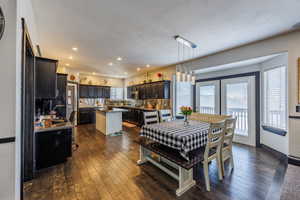 Dining area featuring dark wood finished floors and baseboards
