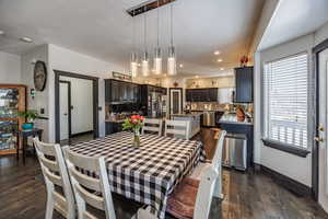 Dining area with dark wood finished floors and recessed lighting