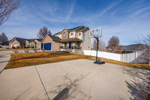 View of front of home featuring covered porch, driveway, and a residential view
