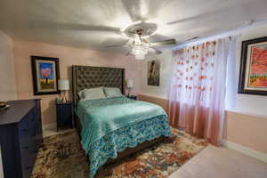 Bedroom with ceiling fan and wood finished floors